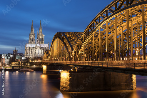 Illuminated Cologne Cathedral and Hohenzollern Bridge At Sunset   Germany