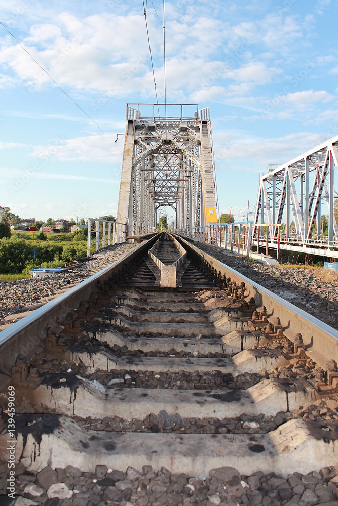Fototapeta premium Railway bridge over the river Vologda, near Vologda