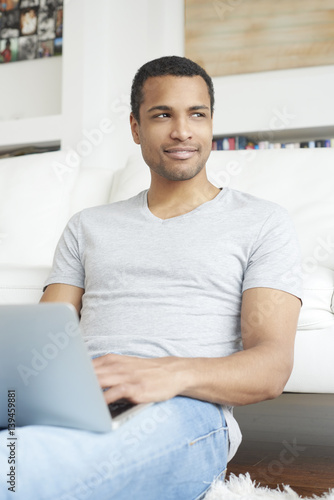 Free Download Home office is a good idea. Afro American businessman working online  - GFXLoad