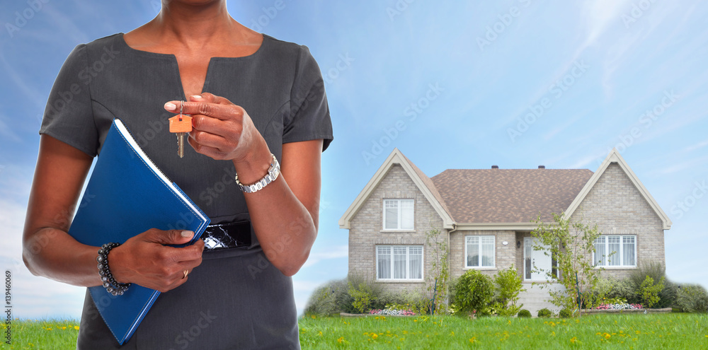 © grinny - African-American realtor woman with key. © grinny - African-American realtor woman with key.