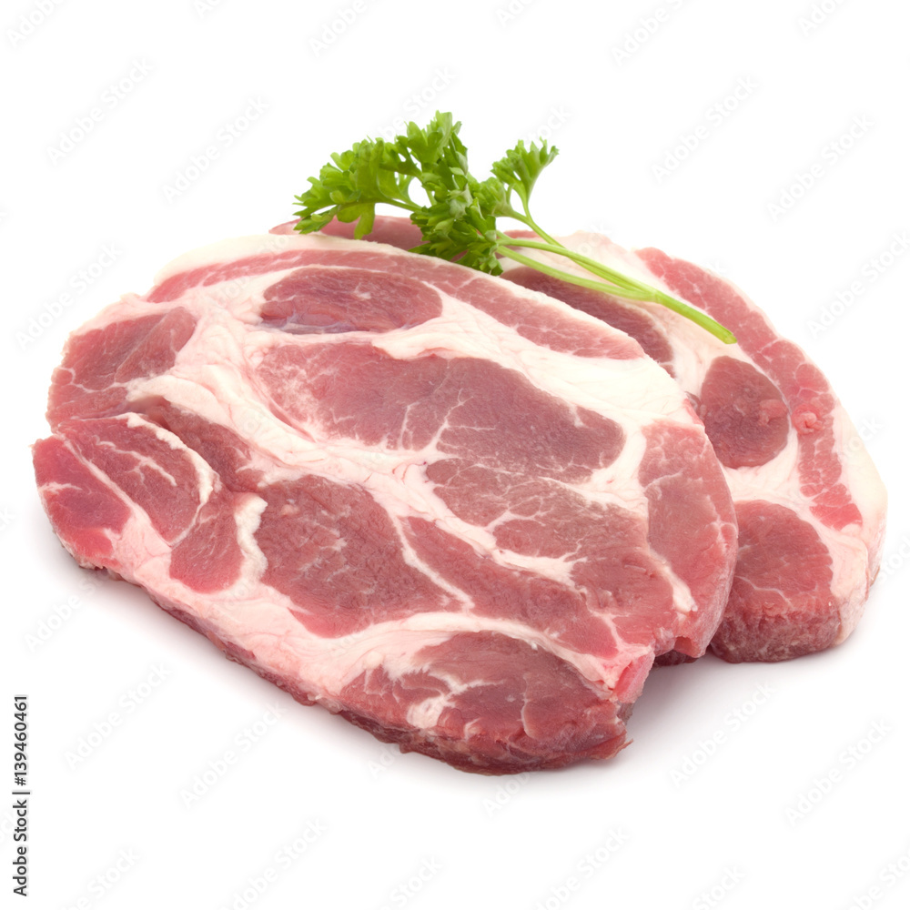 Raw pork neck chop meat with parsley herb leaves garnish isolated on white background cutout Raw pork neck chop meat with parsley herb leaves garnish isolated on white background cutout