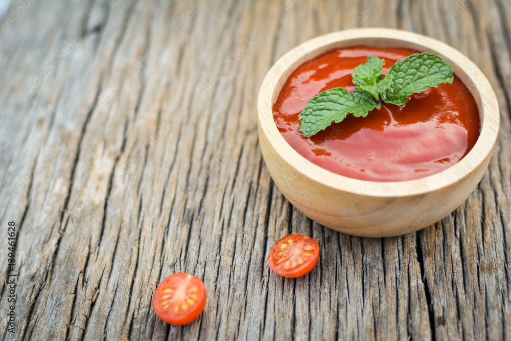tomato sauce in a bowl and fresh tomatoes on old wood tomato sauce in a bowl and fresh tomatoes on old wood