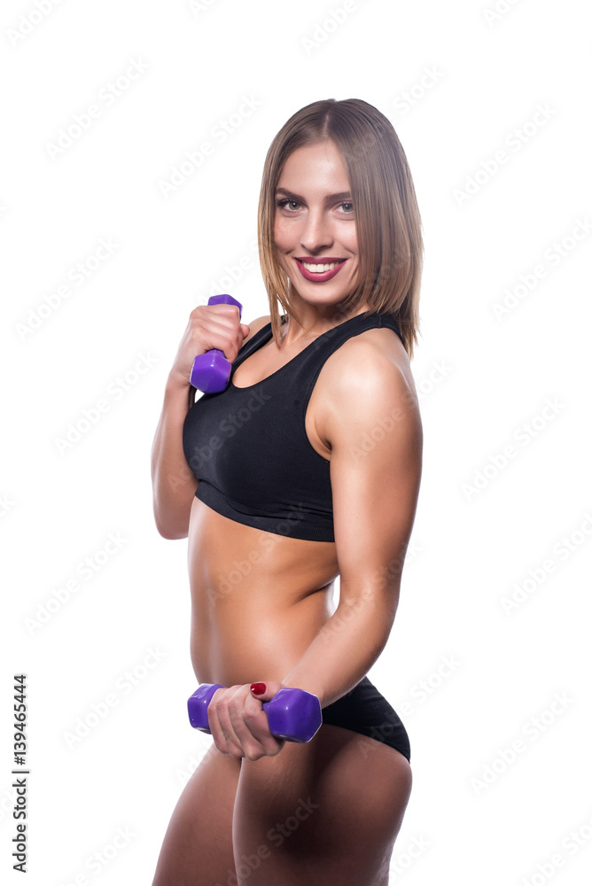 Young beautiful and sexy girl wearing sports clothes working out with dumbbells isolated on white background. Young beautiful and sexy girl wearing sports clothes working out with dumbbells isolated on white background.