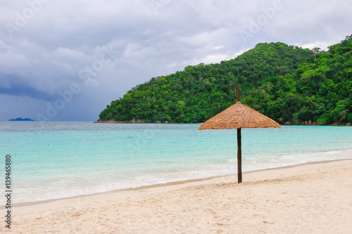 Vacation in tropical countries. Beach chairs, umbrella and palms on the beach - Boost up color Processing.