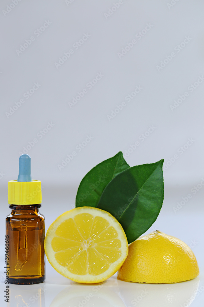 essential oil of lemon, lemon leaf on a light background. organic cosmetics concept essential oil of lemon, lemon leaf on a light background. organic cosmetics concept