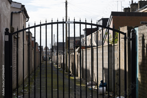 Gated alley with mosque in distance