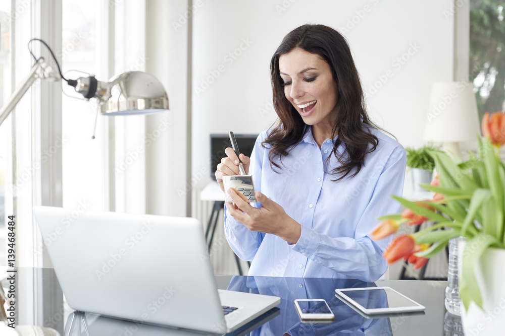 Beauty in the office. Portrait of an attractive businesswoman applying makeup while sitting in front of computer and working in the office. Beauty in the office. Portrait of an attractive businesswoman applying makeup while sitting in front of computer and working in the office.