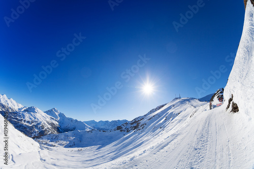 Slika na platnu Snow-covered mountains panorama with ski slopes