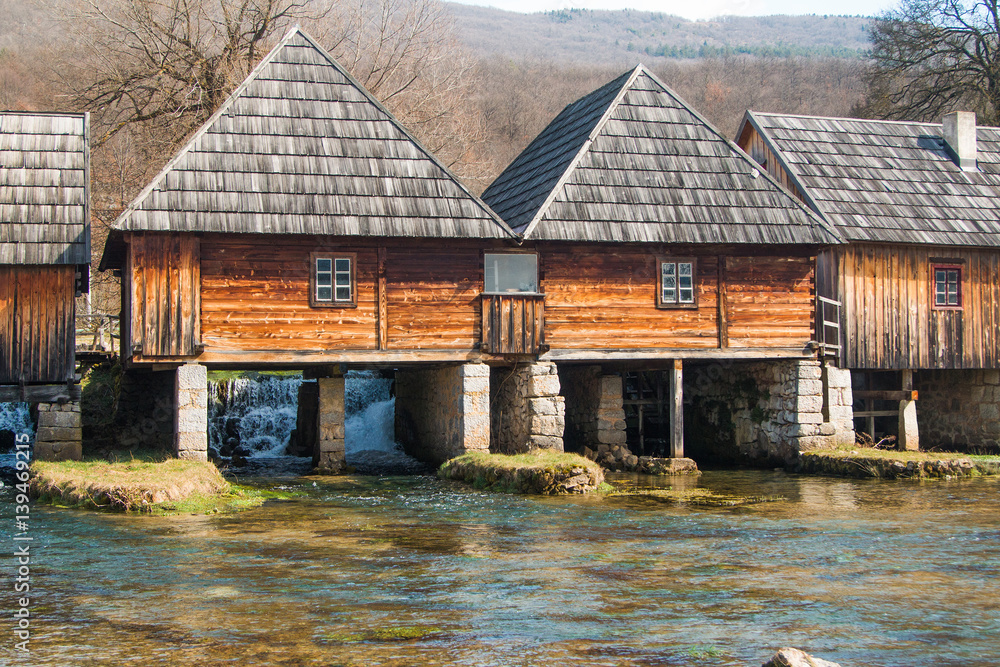 Old wooden water mills in on Majerovo vrilo, source of Gacka river, Lika, Croatia Old wooden water mills in on Majerovo vrilo, source of Gacka river, Lika, Croatia