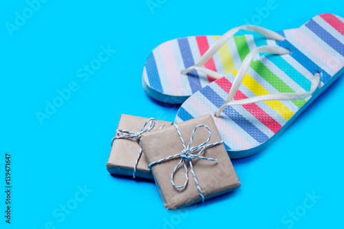 colorful sandals and cute gifts on the wonderful blue background photo