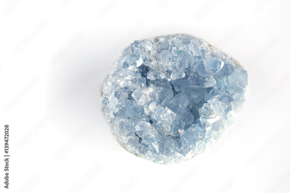 blue crystal Celestine on a white blurred background