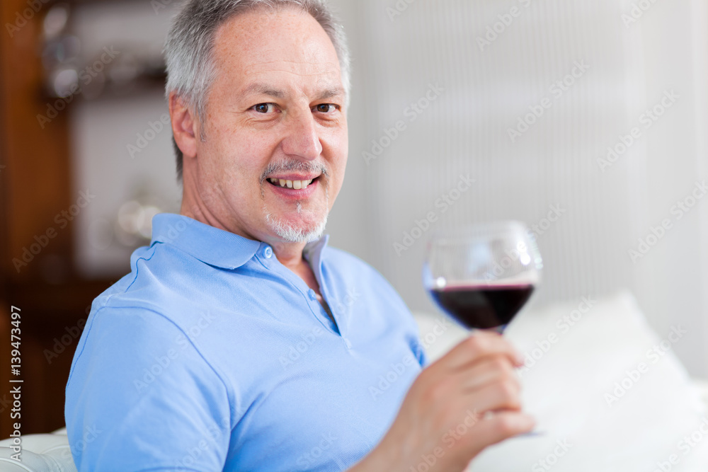 Man holding a glass of red wine Man holding a glass of red wine
