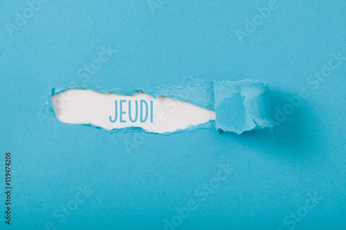 Fotografie Jeudi (French Thursday) weekday message on Paper torn ripped opening