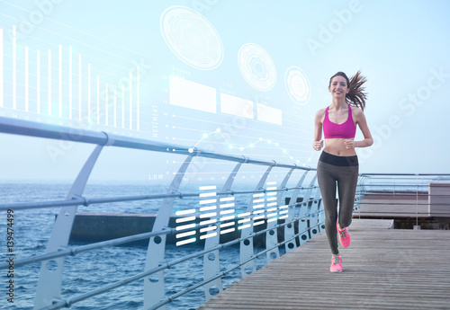 Young woman running on pier