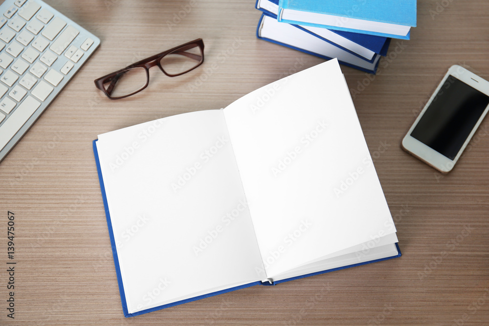 Book, glasses with smart phone on wooden table Book, glasses with smart phone on wooden table
