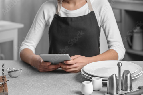 Woman holding tablet and si...