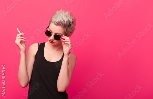 fashion blonde with stylish short hairstyle smoking cigarette