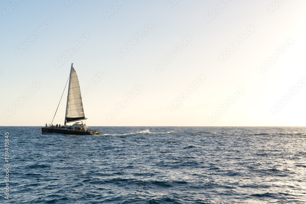 Sailboat sailing over the sea at sunset