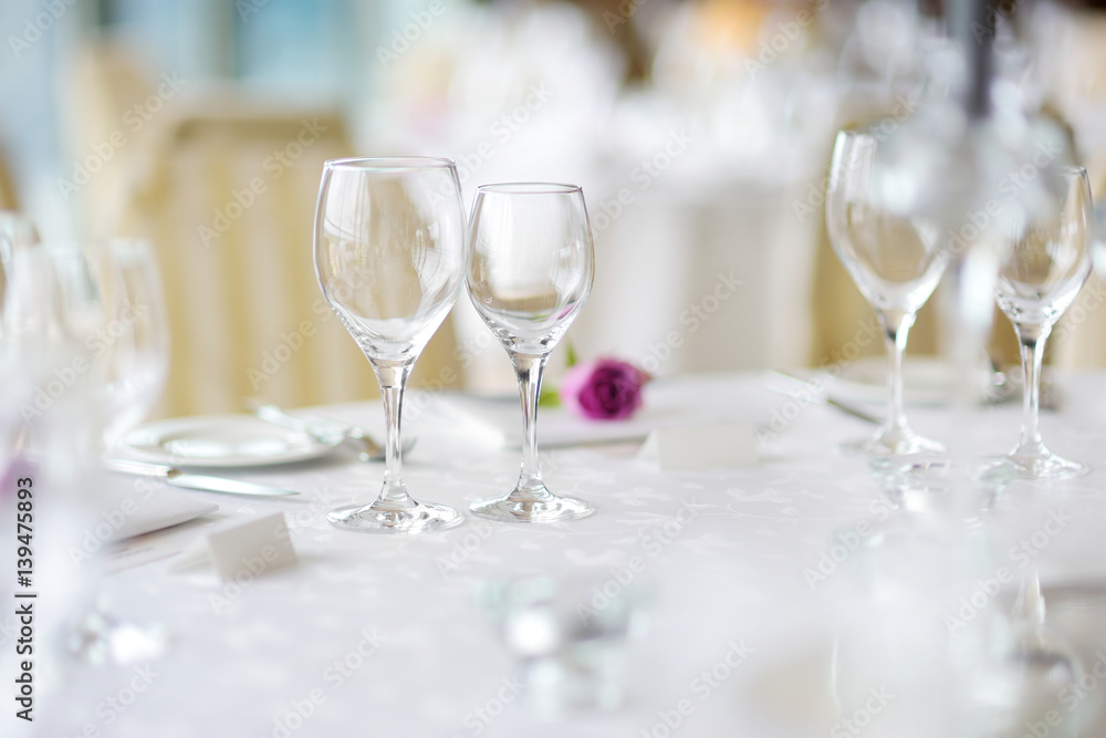 Beautiful table setting with crockery and flowers for a party, wedding reception or other festive event Beautiful table setting with crockery and flowers for a party, wedding reception or other festive event