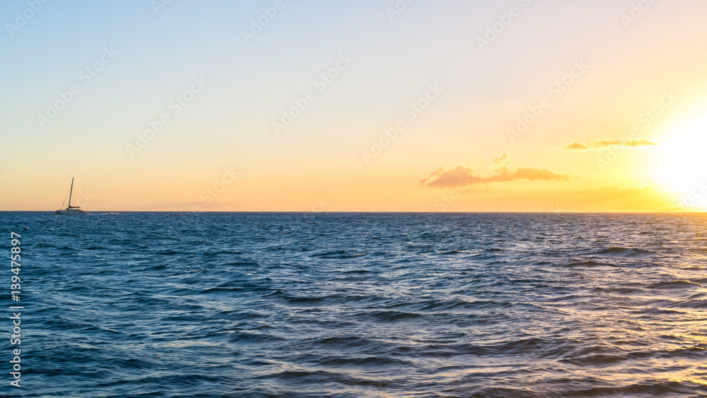 Sailboat sailing over the sea at sunset