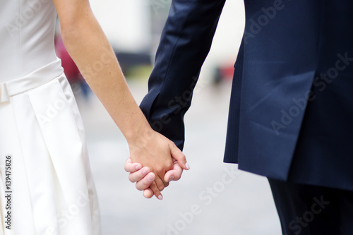 Bride and groom holding their hands