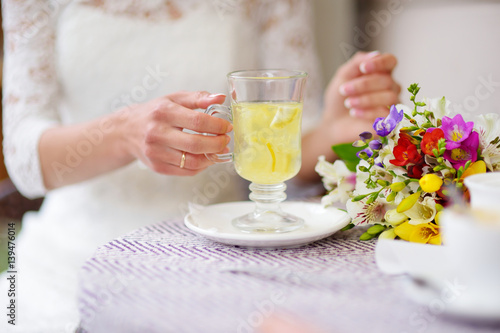 Woman in white dress drinking hot ginger tea