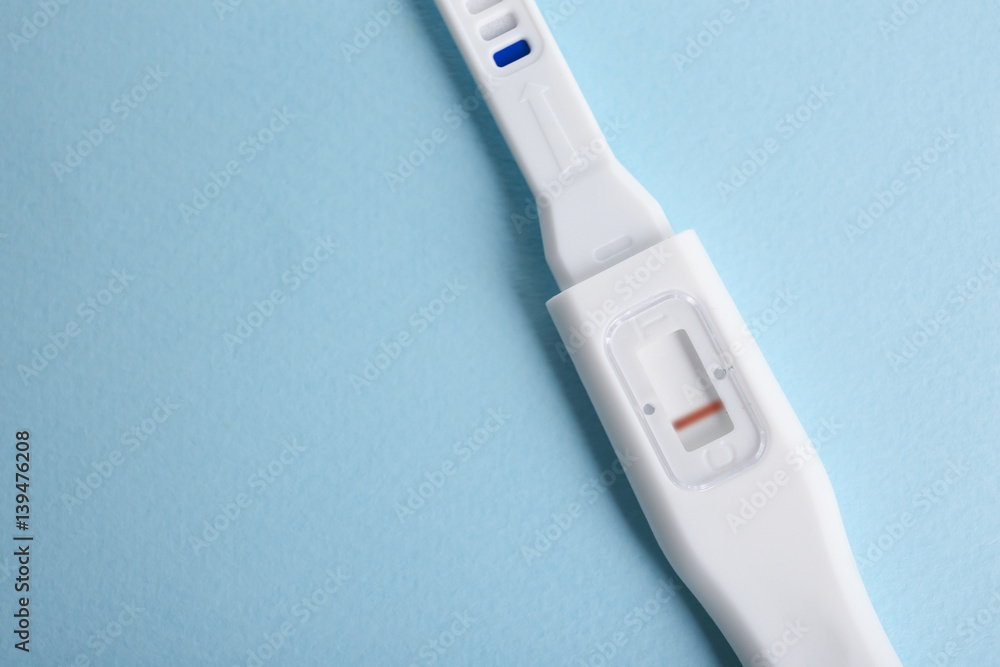 Pregnancy test on turquoise background Pregnancy test on turquoise background