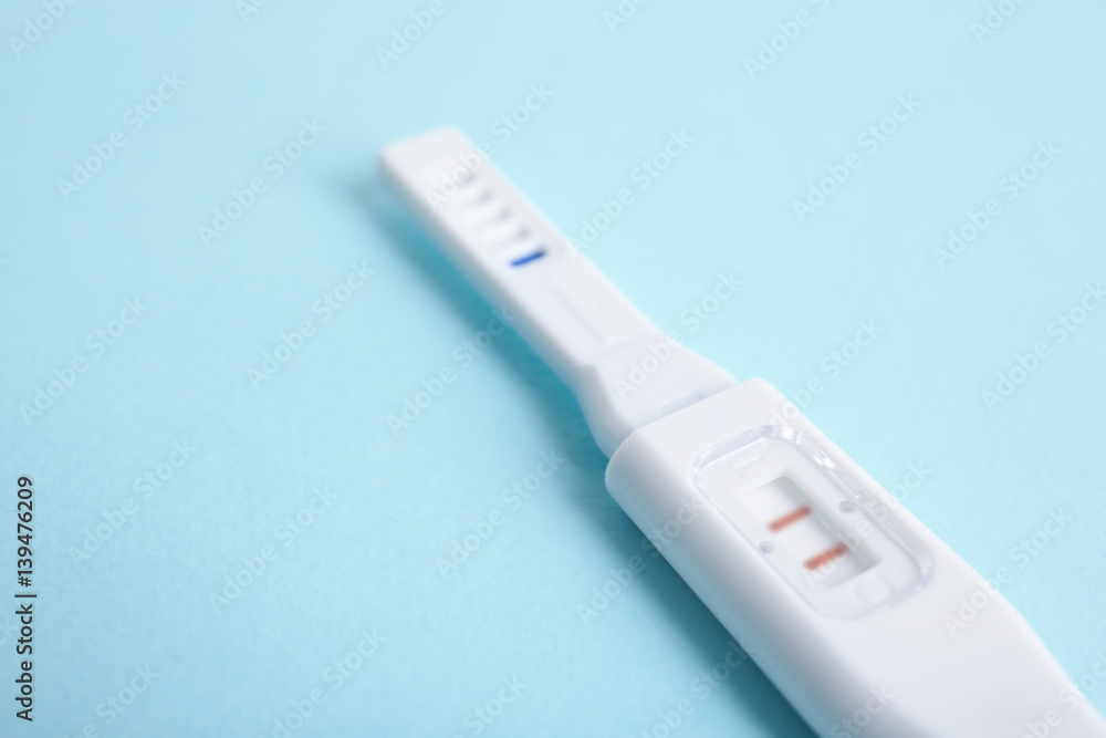 Pregnancy test on turquoise background Pregnancy test on turquoise background