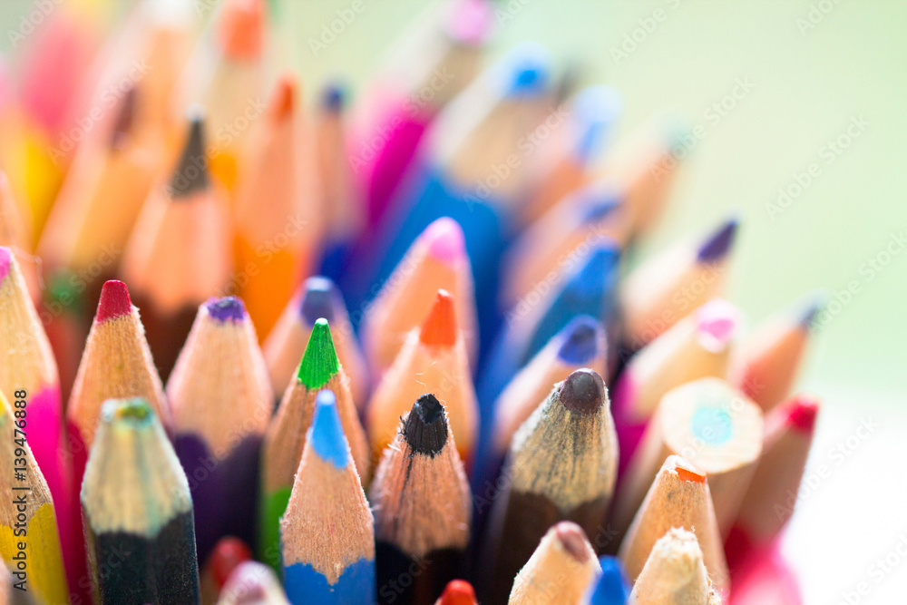 Colorful background made of bunch of wooden pencils in a wide variety of color palette as artistic, school, education and creativity concept Colorful background made of bunch of wooden pencils in a wide variety of color palette as artistic, school, education and creativity concept