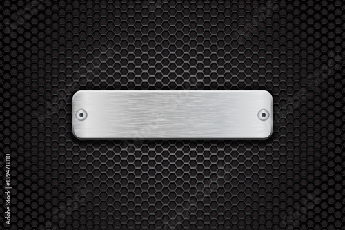 Blank metal button plate. On dark metal perforated background