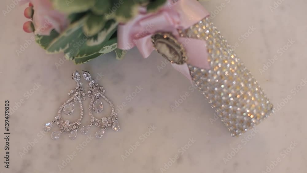 Bridal bouquet and earrings indoors Bridal bouquet and earrings indoors