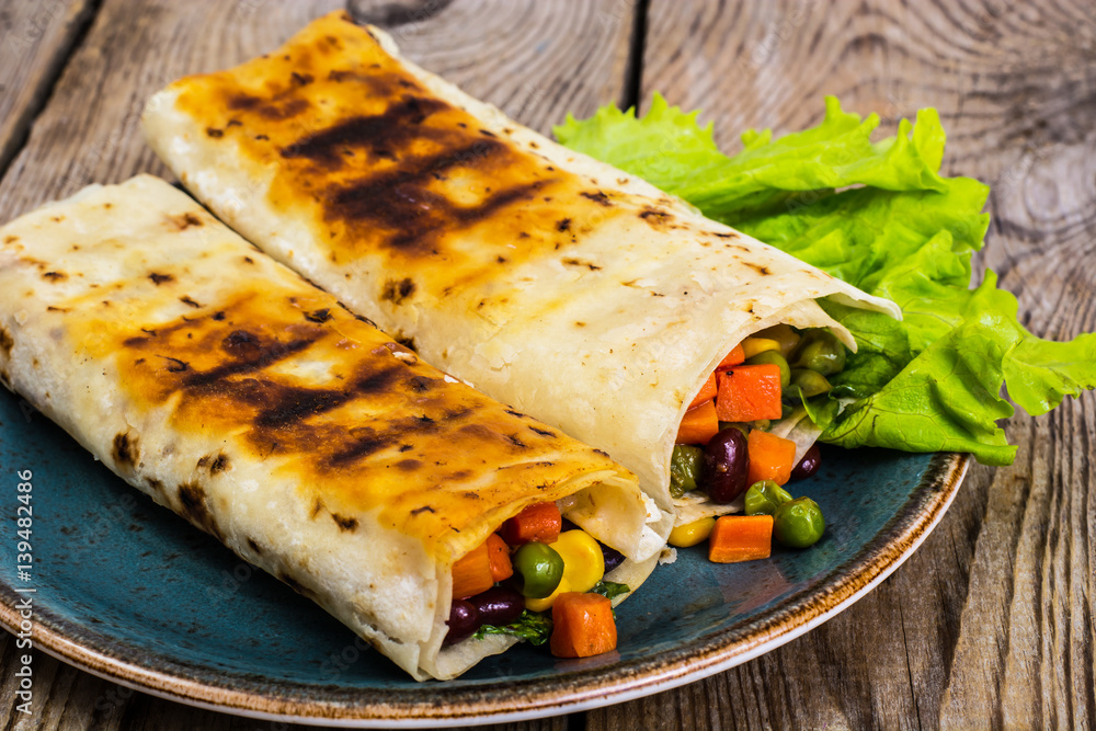 Tortilla with vegetable mix on blue plate Tortilla with vegetable mix on blue plate