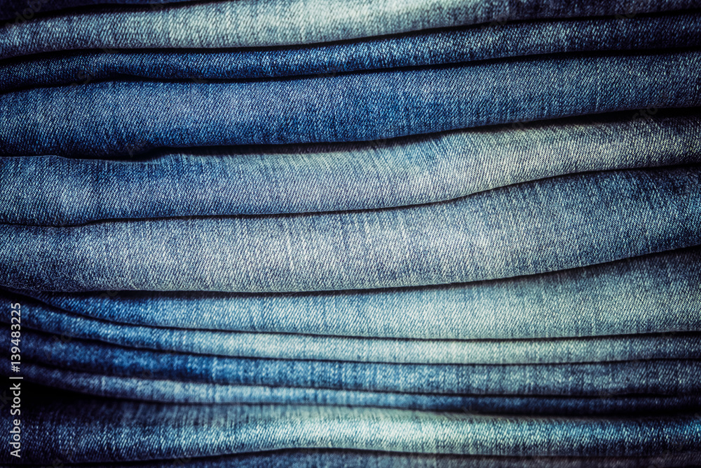 Detail of blue jeans stack with selective focus