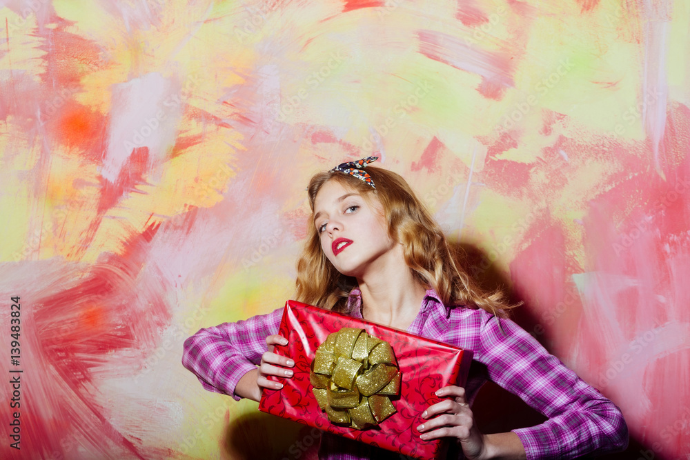 Fototapeta premium Pretty girl with red gift box with golden bow