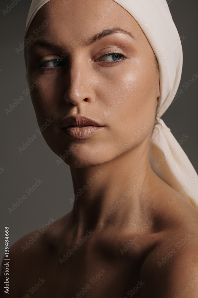 Fototapeta premium Female model with natural makeup and head scarf