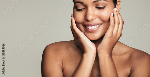 Smiling young woman with clean and healthy skin
