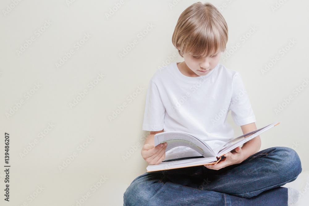 Little kid reading a book. Education, school, leisure concept Little kid reading a book. Education, school, leisure concept