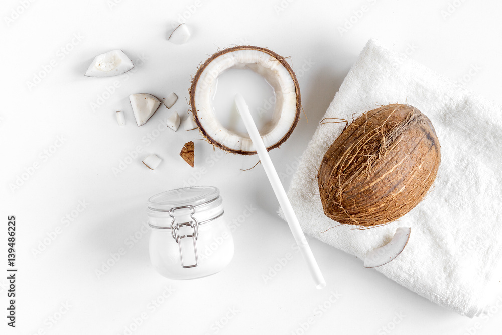 Fototapeta premium organic cosmetics with coconut on white background top view