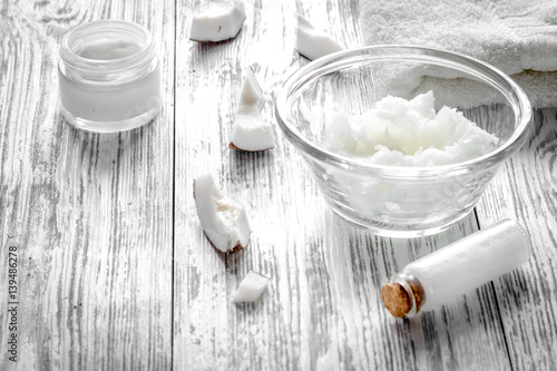 organic cosmetics with coconut on wooden background close up