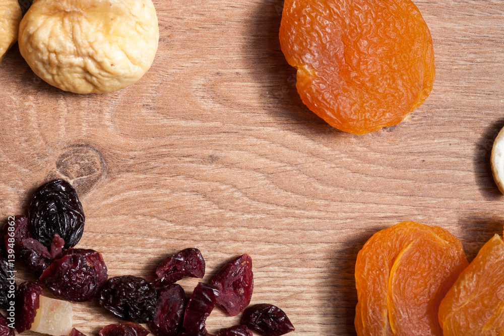Different type of dried fruits on wooden background