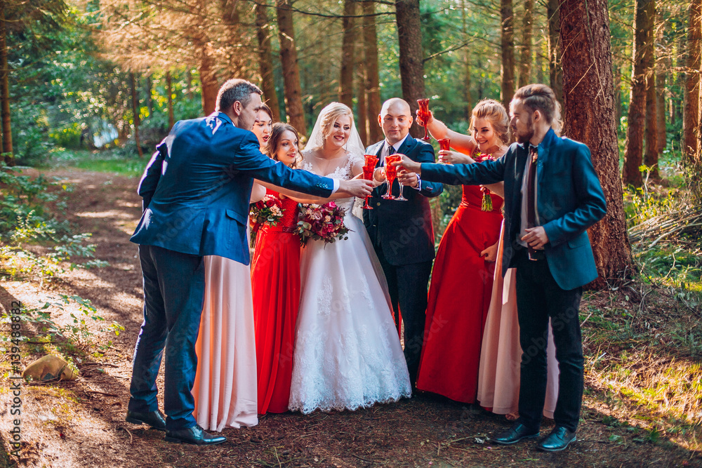 Bride and groom with happy groomsmen and bridesmaids having fun and popping champagne ilarious moment. Newlyweds fun with friends. Dancing people. Bride and groom with happy groomsmen and bridesmaids having fun and popping champagne ilarious moment. Newlyweds fun with friends. Dancing people.