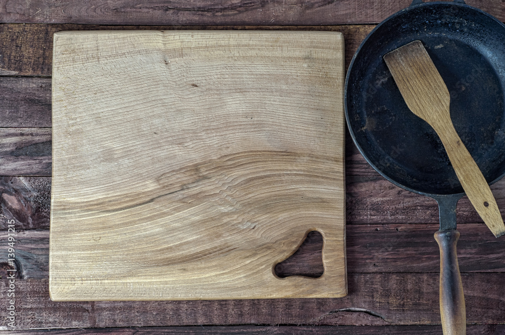 large wooden cutting board on brown surface