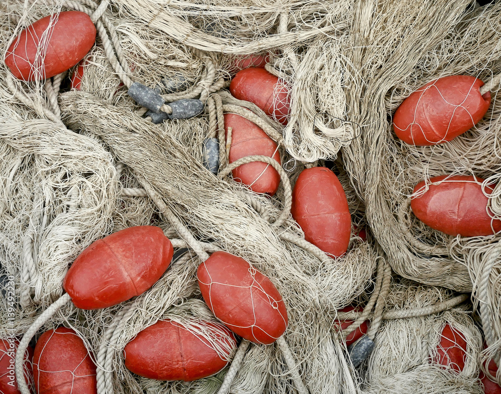 Fishing net with red cork floats. Stock Photo