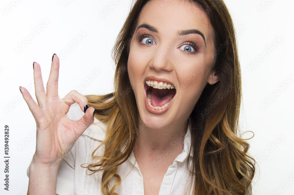 young woman with brace close up under magnifier smiling on white young woman with brace close up under magnifier smiling on white