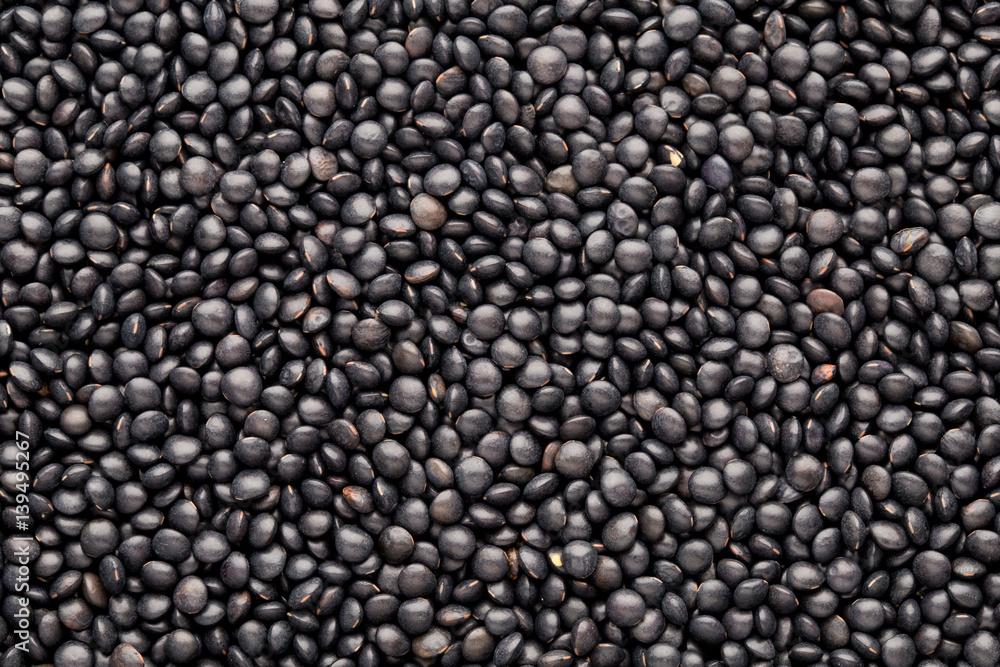 Food and cookery background of healthy dried black lentils. Food and cookery background of healthy dried black lentils.
