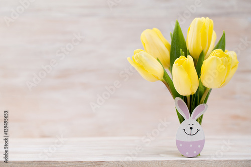 Yellow tulips, spring flowers and Easter decoration.