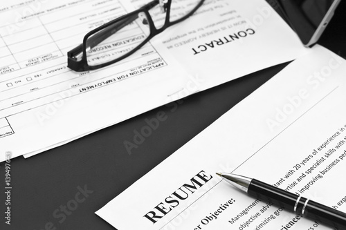 Closeup of Resume with Pen and Glasses on the Table 