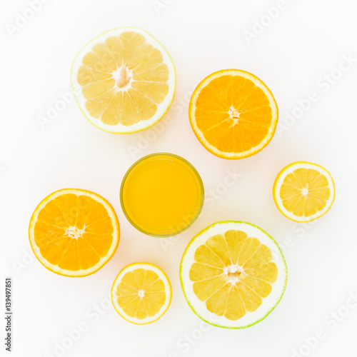 Citrus fruits and juice - lemon, orange, grapefruit, sweetie isolated on white background. Flat lay, top view. Summer background