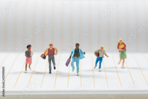 businee miniature people running on notebook line