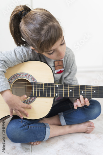 9 year old girl learning to play the guitar.